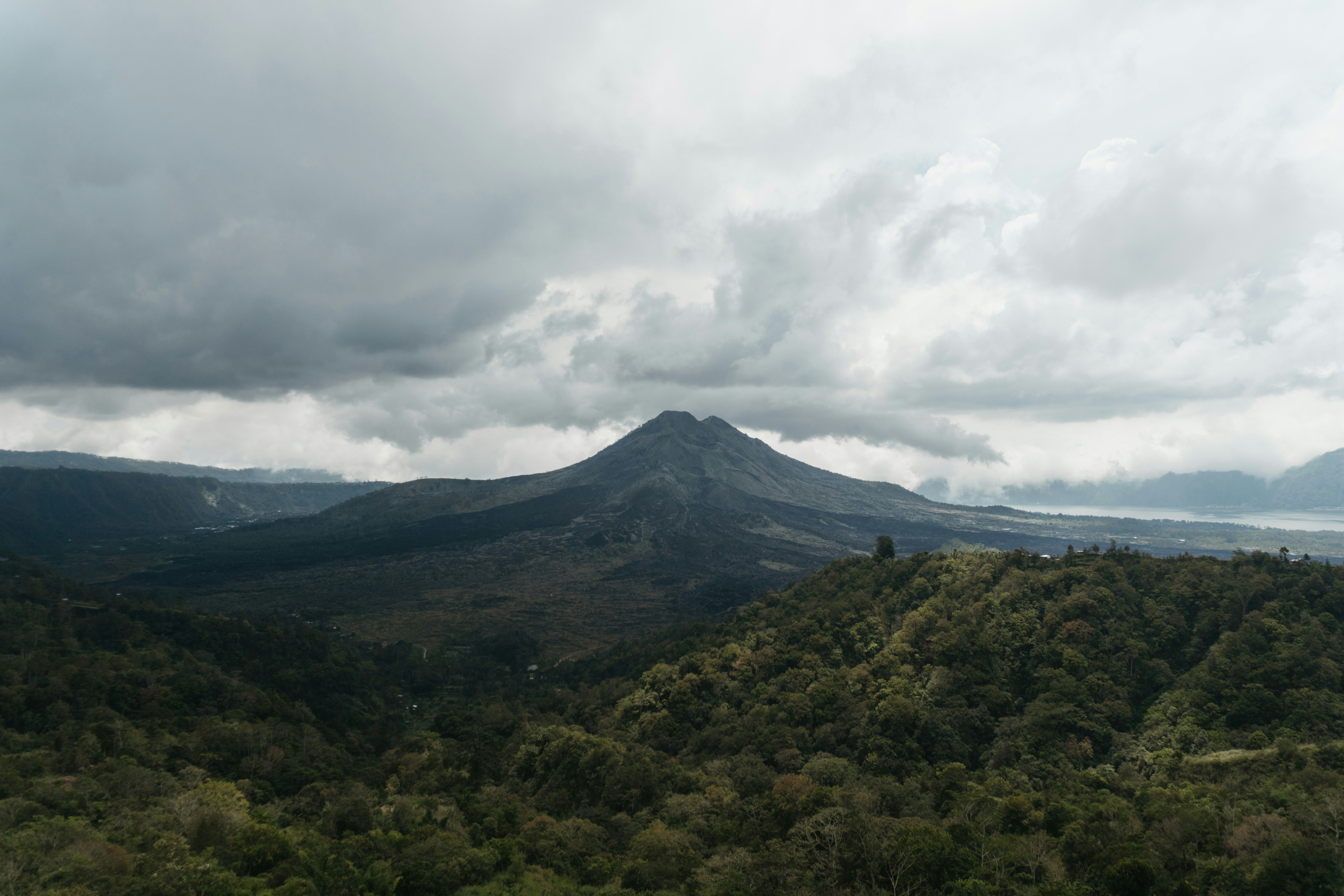 green mountain under white clouds during daytime